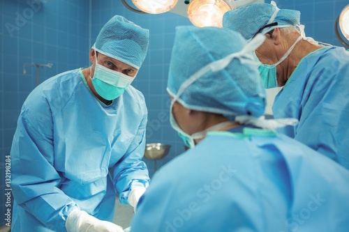 Team of surgeons performing operation in operation theater