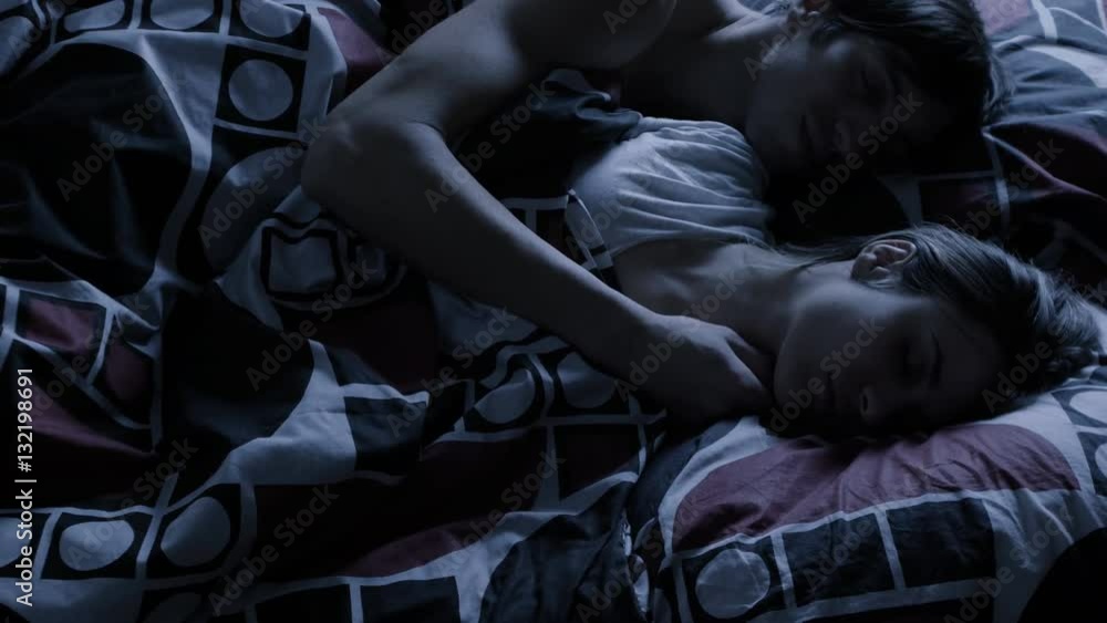 Young couple sleeping together at night Young couple sleeping together at night