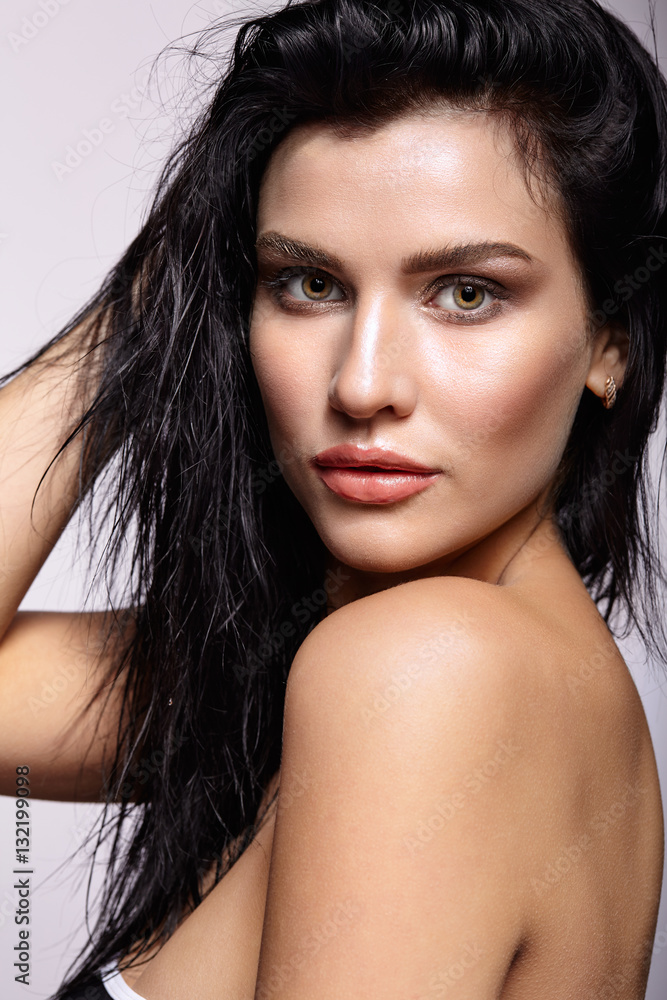 Portrait of a young brunette woman with hining wet make-up and s Portrait of a young brunette woman with hining wet make-up and s
