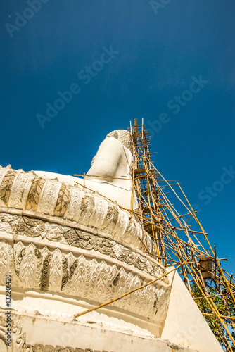 White buddha statue under construction at Phra That Maeyen templ photo