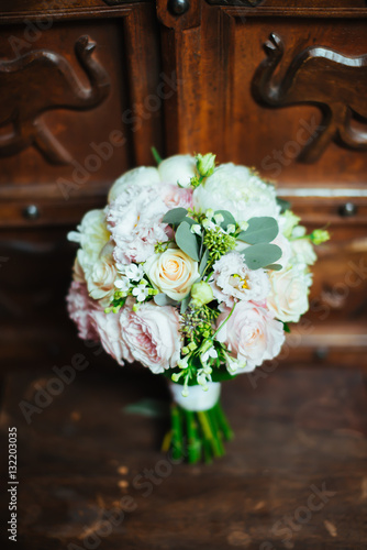 Beautiful bridal bouquet on the wooden background © Dmitriy Shipilov