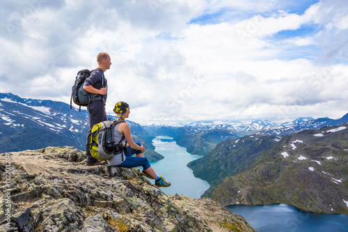 Happy people relax in cliff during trip Norway. Bessegen area © lkoimages