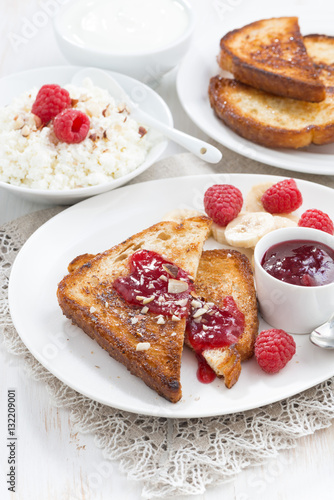 sweet breakfast - crispy toasts with raspberries, banana and jam