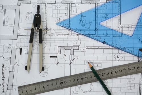 Blueprint with ruler, pencil and thumbscrew compasses