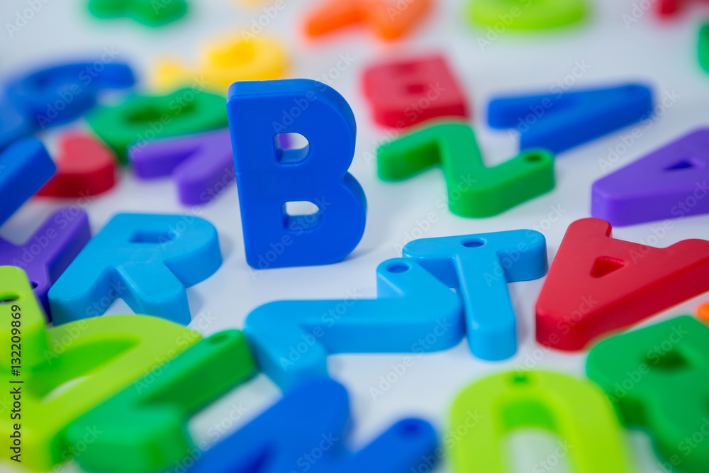 B alphabet standing between toy alphabet B alphabet standing between toy alphabet