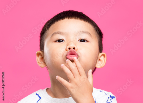 Asian little boy kisses you