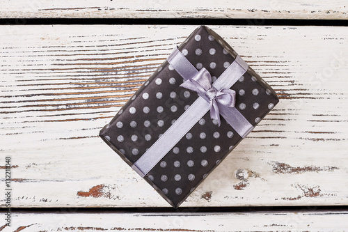 Black box with violet bow. Spotted present box and ribbon. Where to buy a gift.