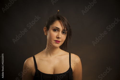 Beauty portrait of young caucasian woman. Black background with yellow backlight