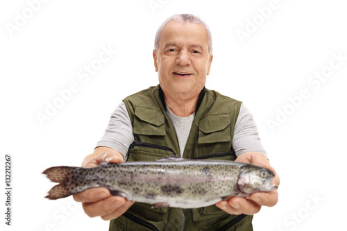 Elderly fisherman holding a fish