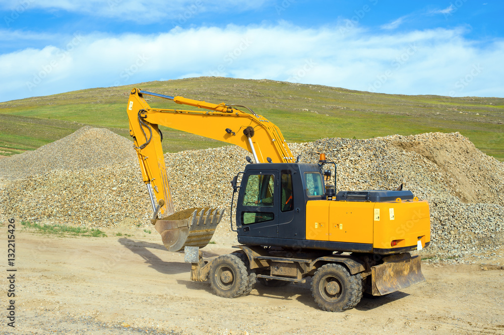 Wheel excavator on the construction of a new road in the steppe zone Wheel excavator on the construction of a new road in the steppe zone