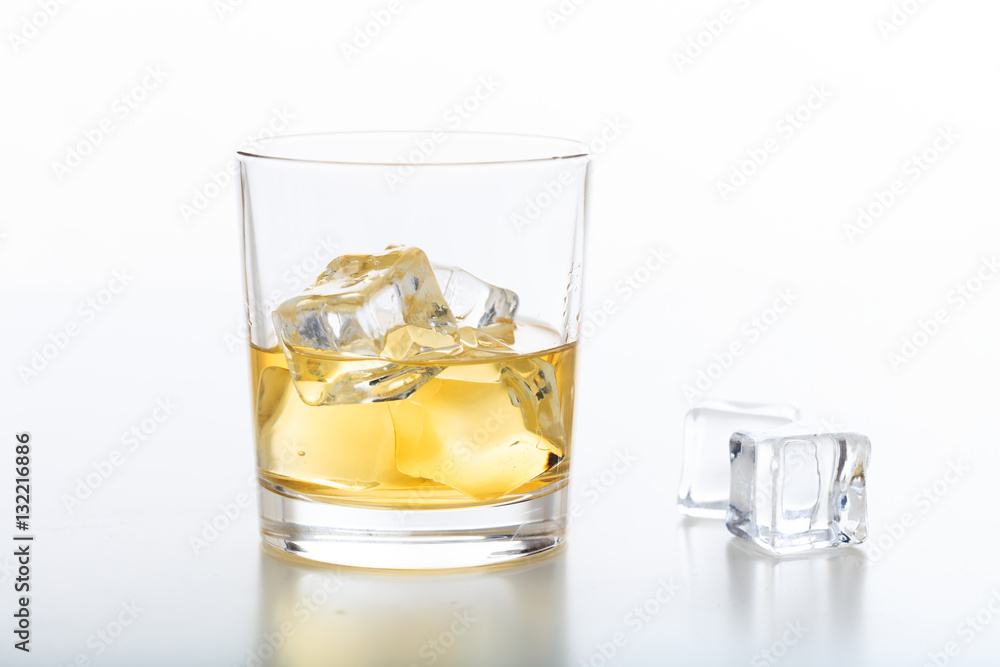 Glass of whiskey and ice on white background Glass of whiskey and ice on white background