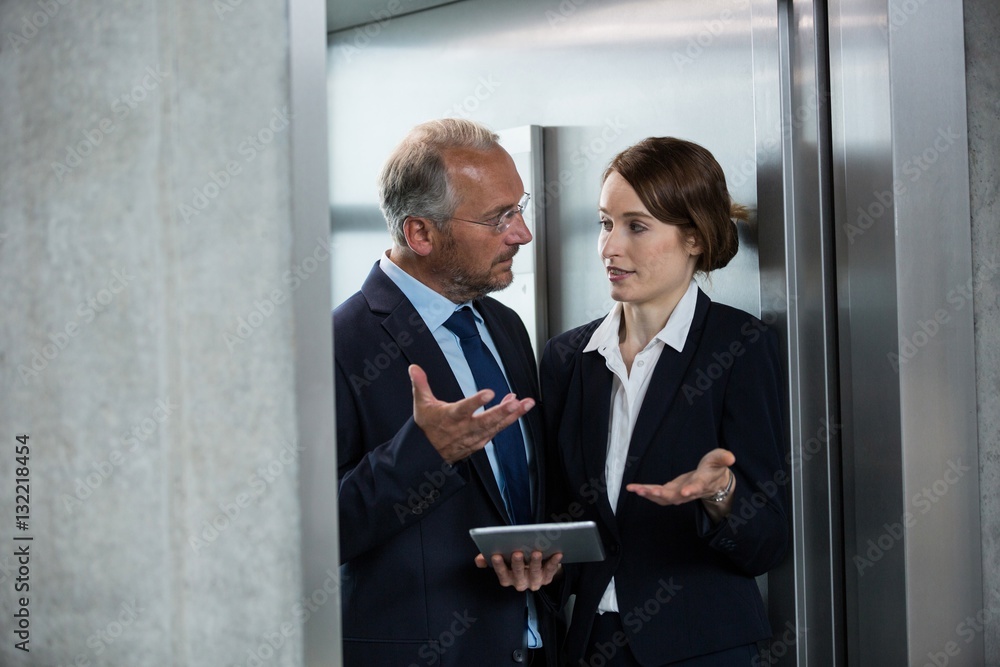 Businessman with colleague in an elevator Businessman with colleague in an elevator