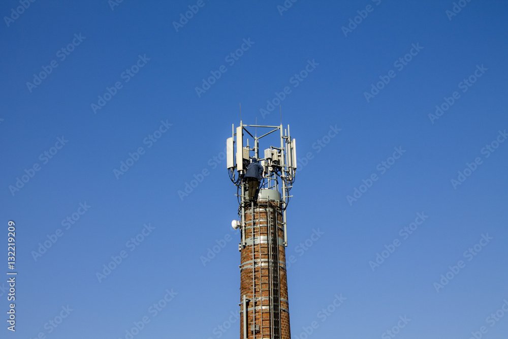 Obraz premium A man working at heights on the chimney