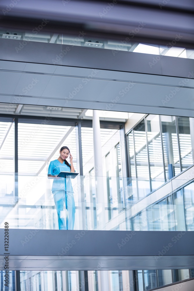 Nurse holding a diary while standing Nurse holding a diary while standing