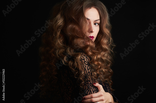 fashion Portrait of beautiful young woman with curly healthy hair.mysterious girl.hairstyle