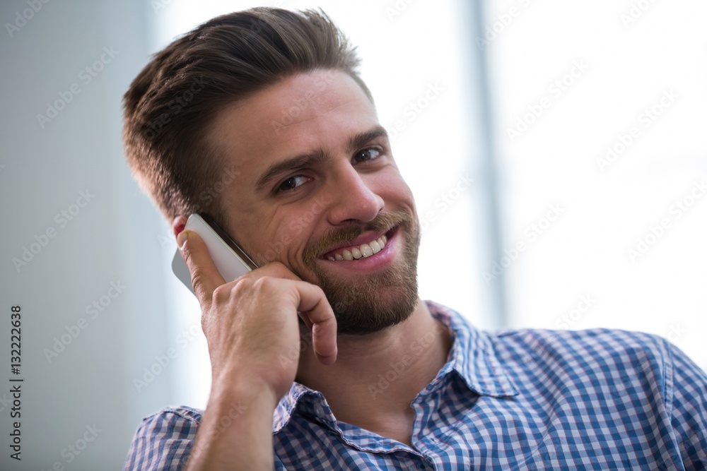 Graphic designer talking on mobile phone Graphic designer talking on mobile phone