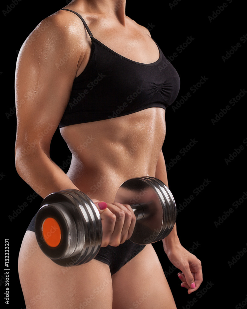 Fototapeta premium Athletic girl with dumbbells in hand.