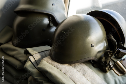 Military helmets with ammunition background