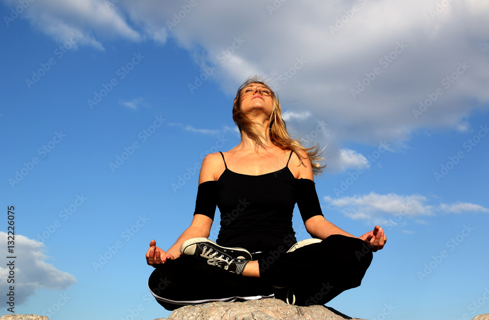 Blonde woman practicing yoga outdoors Blonde woman practicing yoga outdoors