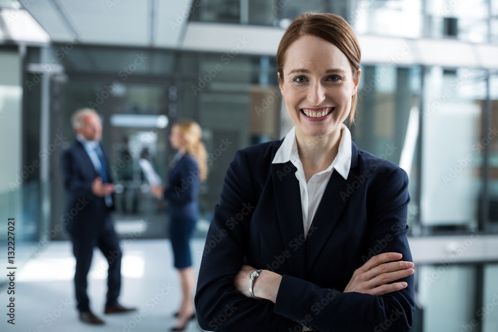 Portrait of businesswoman standing with arms crossed