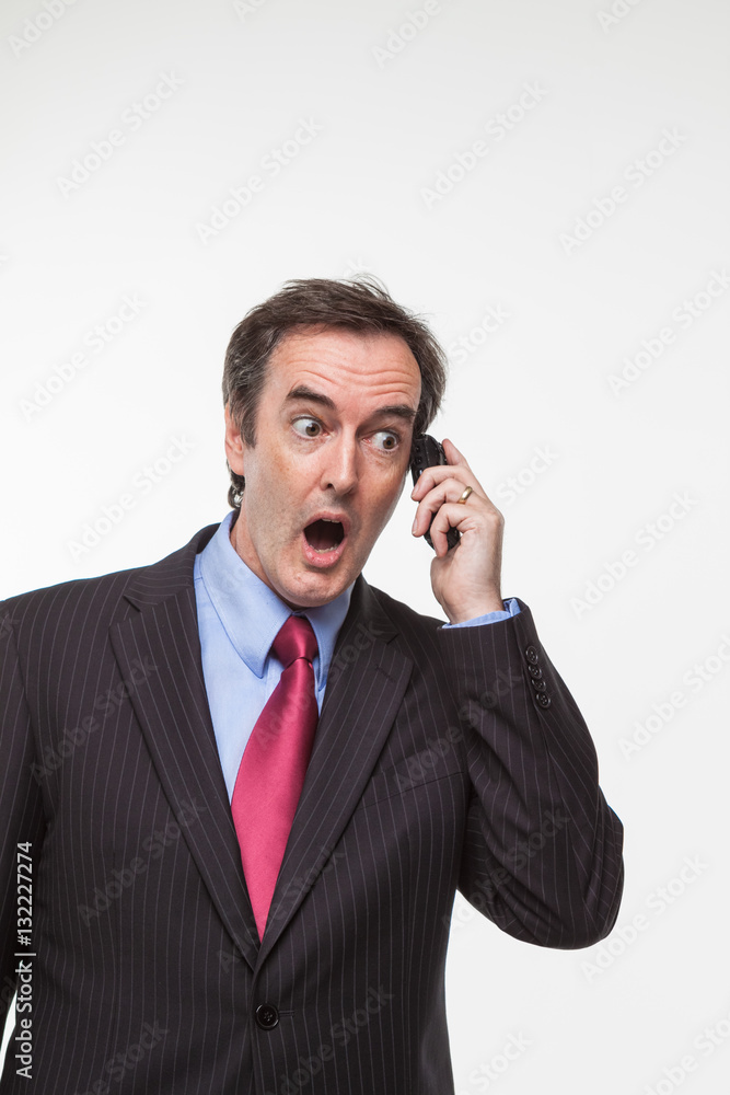 Surprised businessman on cell phone Surprised businessman on cell phone