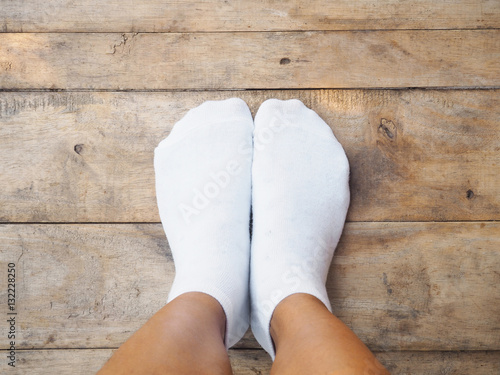  feet wearing white socks on wood photo