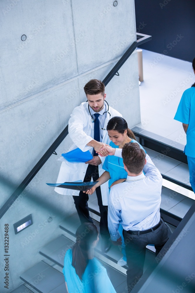 Doctor and nurse discussing over a report Doctor and nurse discussing over a report
