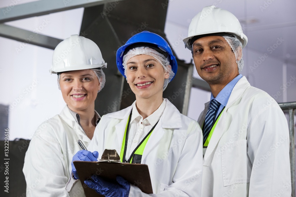 Team of technicians standing in meat factory Team of technicians standing in meat factory