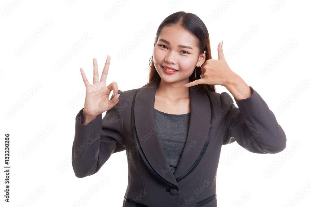 Young Asian woman show with phone gesture and OK sign. Young Asian woman show with phone gesture and OK sign.