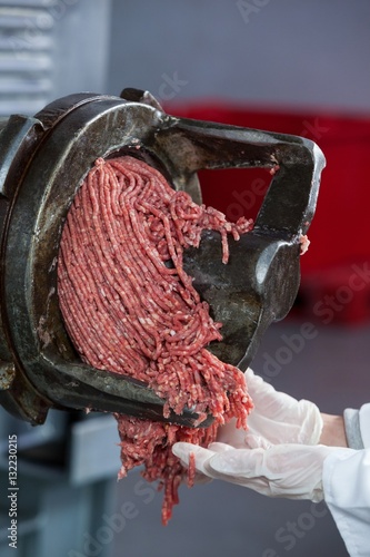 Minced meat coming out from grinder