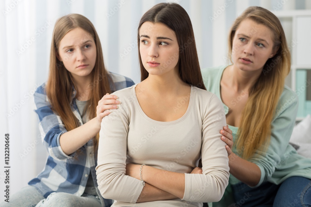 Teenager supported by worried friends Teenager supported by worried friends