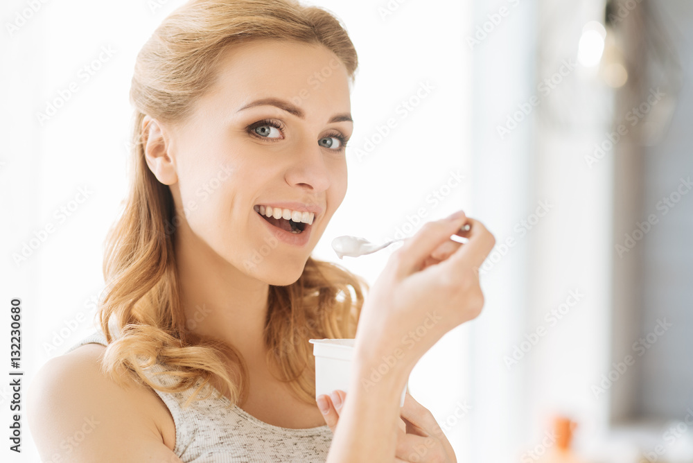 Young pregnant woman eating yoghurt Young pregnant woman eating yoghurt