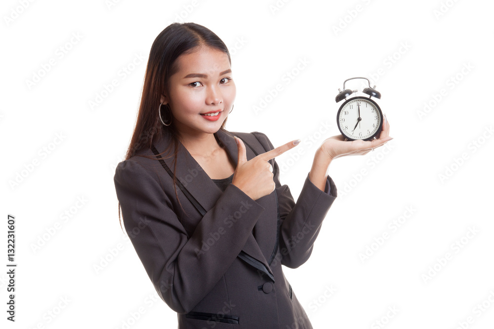 Young Asian business woman point to a clock. Young Asian business woman point to a clock.
