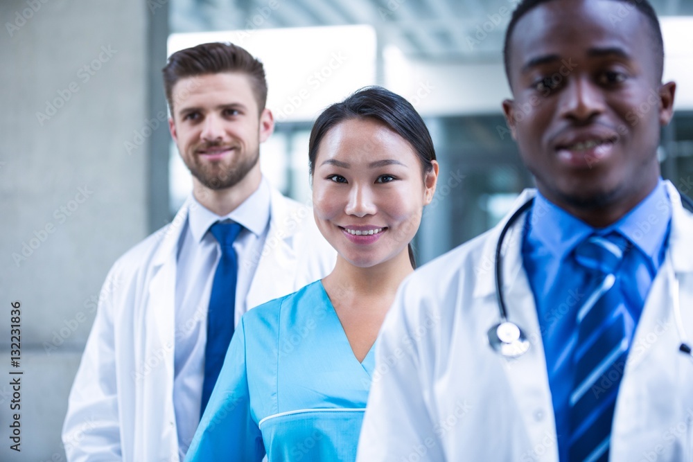 Confident nurse standing with colleagues Confident nurse standing with colleagues