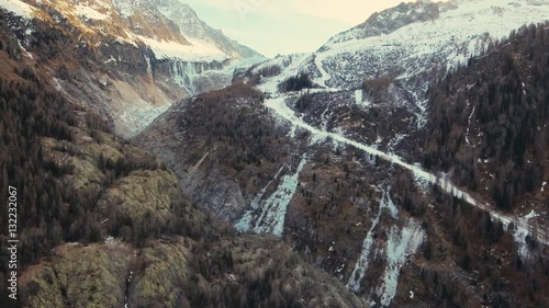 Drone Views over a frozen river and the Glacier of Argentiere, located in the Chamonix valley in the French alps. photo