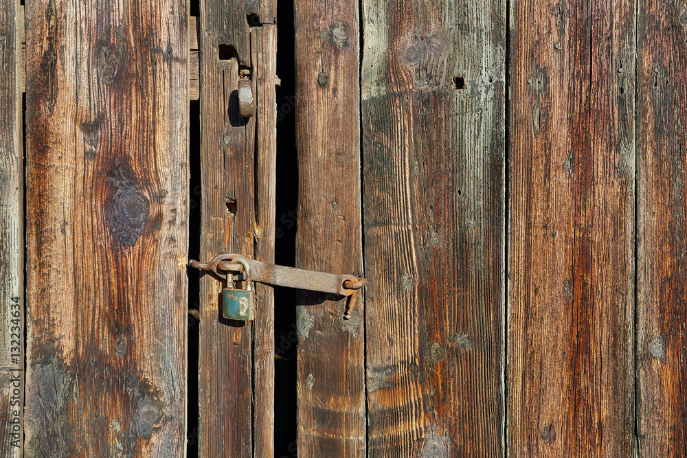 Old wooden door with padlock Old wooden door with padlock