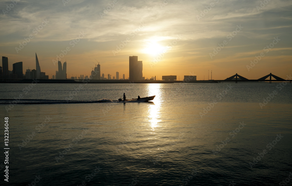 Bahrain skyline  and a moving boat