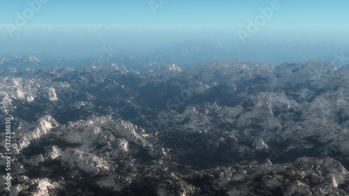 Aerial of mountain range covered with snow.