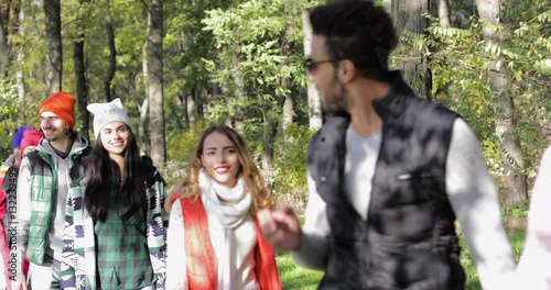 Young People Group Walk Outdoors In Autumn Park, Mix Race Friends Couples Communication Slow Motion 60