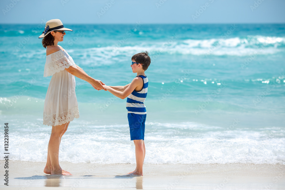 Young mother and her son at Thai beach, Koh Phangan island, Thailand Young mother and her son at Thai beach, Koh Phangan island, Thailand