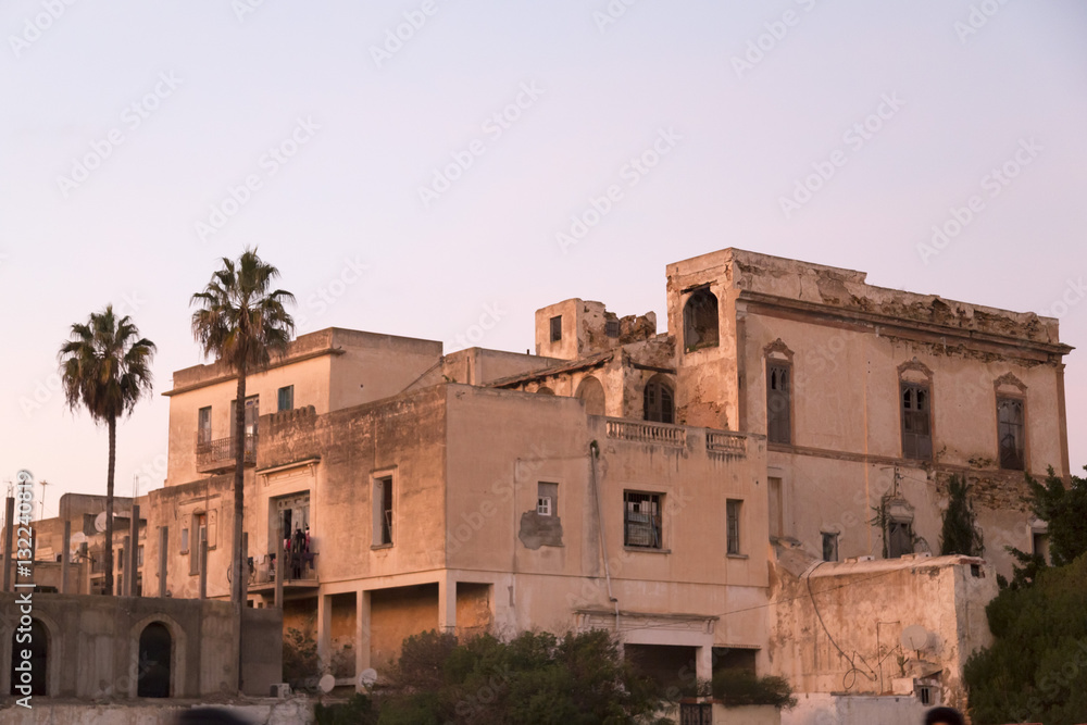 An obsolete building in La Marsa district of Tunis, orange evening light.