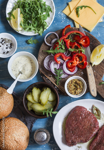 Ingredients for cooking steak burger. On wooden background  top view. Flat lay