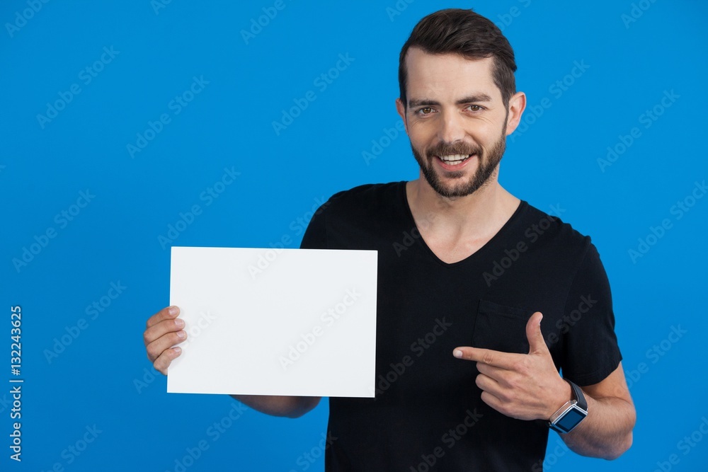 Handsome man holding a blank placard Handsome man holding a blank placard