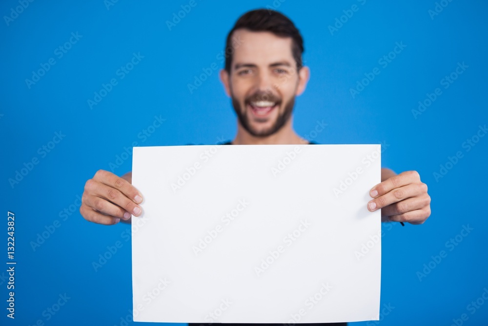 Handsome man holding a blank placard Handsome man holding a blank placard