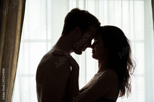 Couple with closed eyes. Woman and man near window. My love is true.