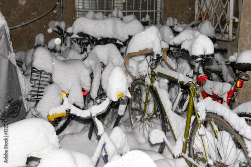 plenty parked bikes covered by thick snow layer