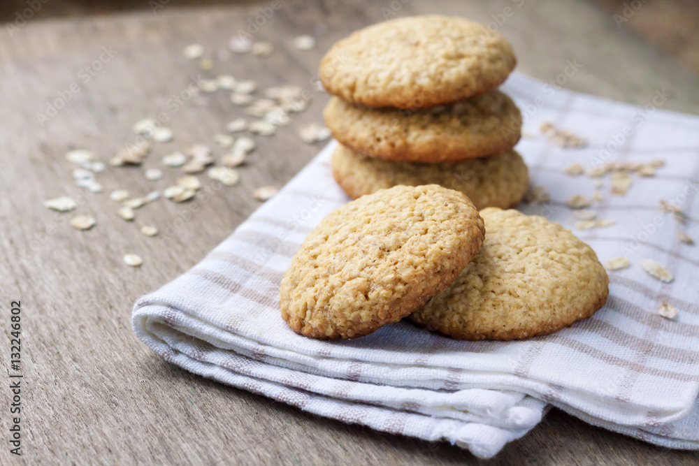 Homemade oatmeal cookies on checkered kitchen towel Homemade oatmeal cookies on checkered kitchen towel