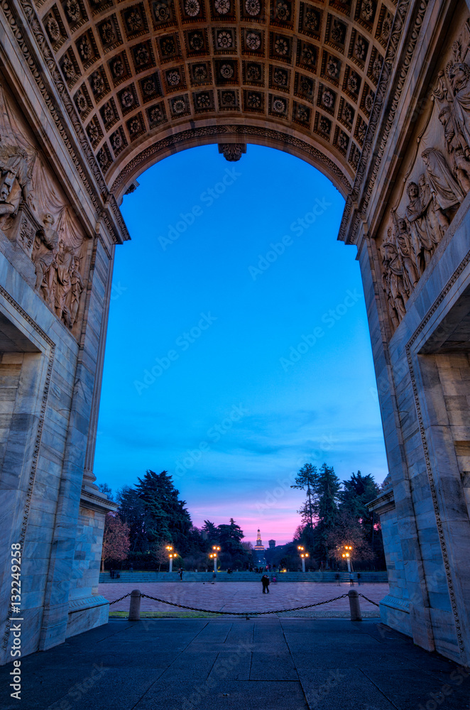 Sunset view of the Arch of Peace (Arco della Pace) in Sempione Park, Milan, Italy. The Sforza Castle (Castello Sforzesco) in the background.