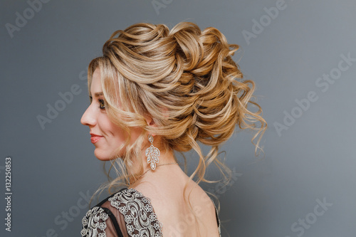 Model blonde Woman with perfect hairstyle and creative hair-dress  back view