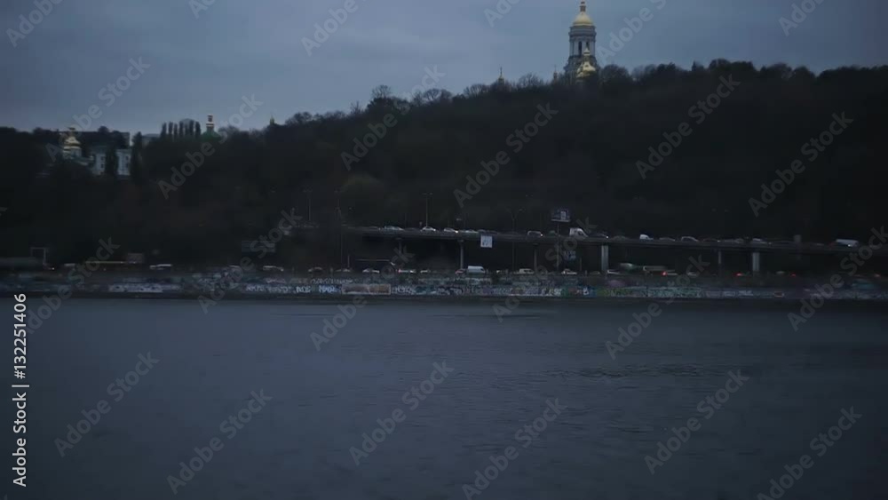Busy traffic along the waterfront in the evening, view of the orthodox church from the river hd Busy traffic along the waterfront in the evening, view of the orthodox church from the river hd